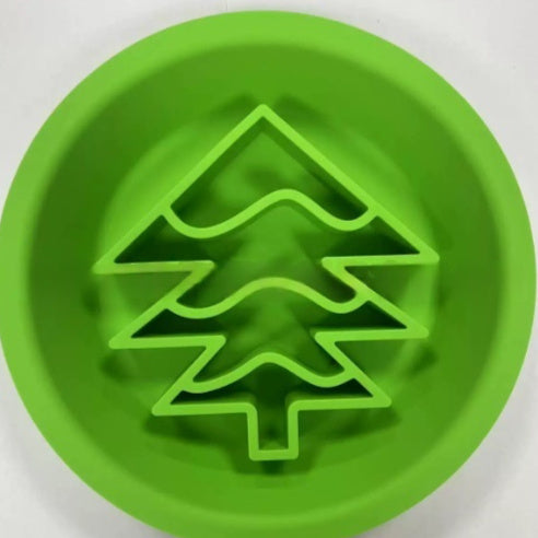 Green circular pet licking mat with a raised Christmas tree pattern