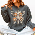 Dark gray Halloween sweatshirt with a skeleton rib cage and pumpkin graphic