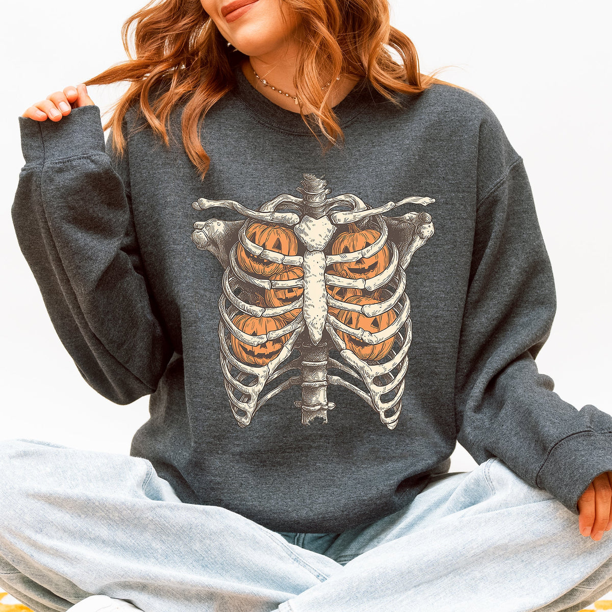 Dark gray Halloween sweatshirt with a skeleton rib cage and pumpkin graphic