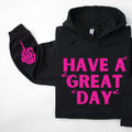 Black Have a Great Day hoodie with pink lettering and a skeleton middle finger sleeve graphic