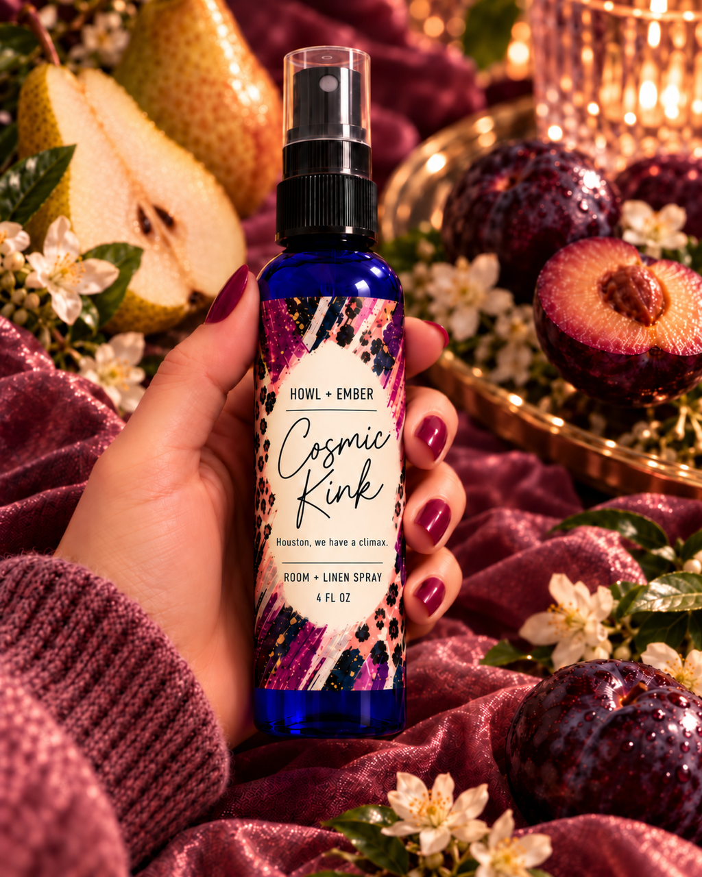 Howl + Ember Cosmic Kink room and linen spray 4 oz in cobalt-blue bottle, plum and pear lifestyle scene with Houston, we have a climax tagline