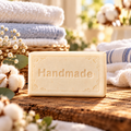 Freshly Folded shea butter soap, a single Handmade embossed bar with a fragrance-inspired background