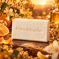 Golden Hour 4 oz handmade shea butter soap with fragrance-inspired background